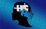 A puzzle of a person's silhouette with two pieces removed from area where brain would be.